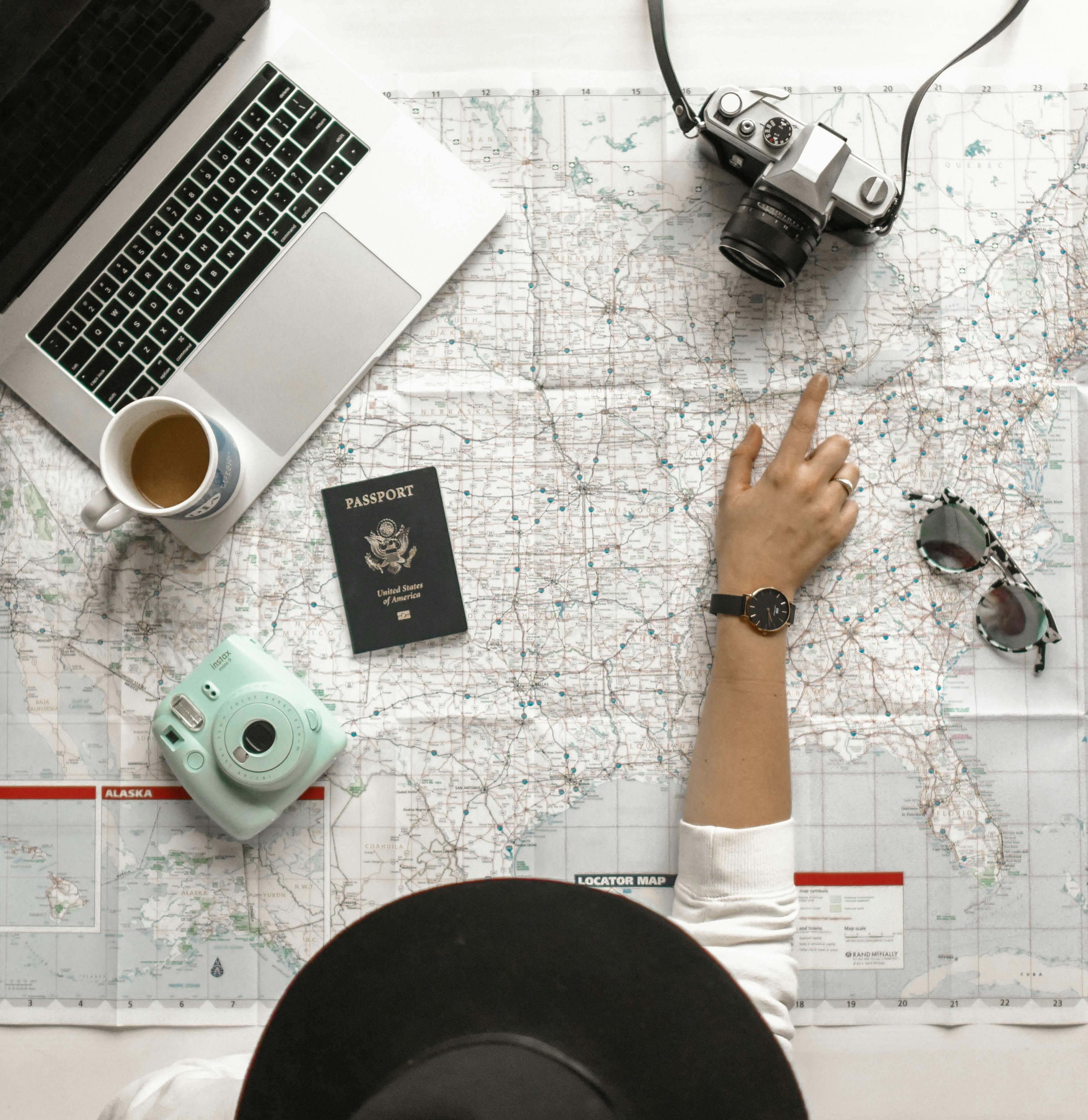 A physical map and travel accessories laid out on a table, as a symbol of customer mapping