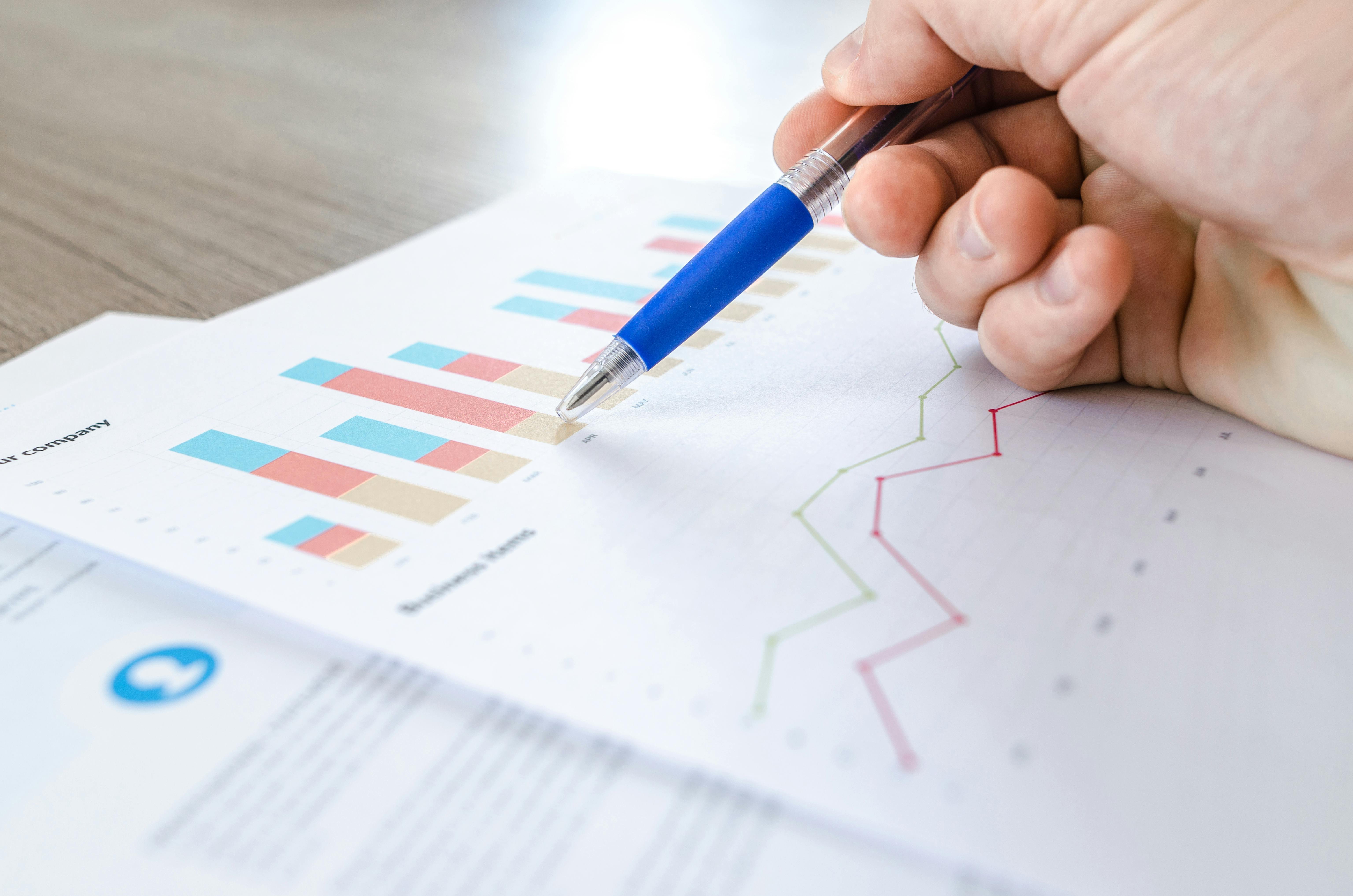 charts on paper, being examined by an unseen person